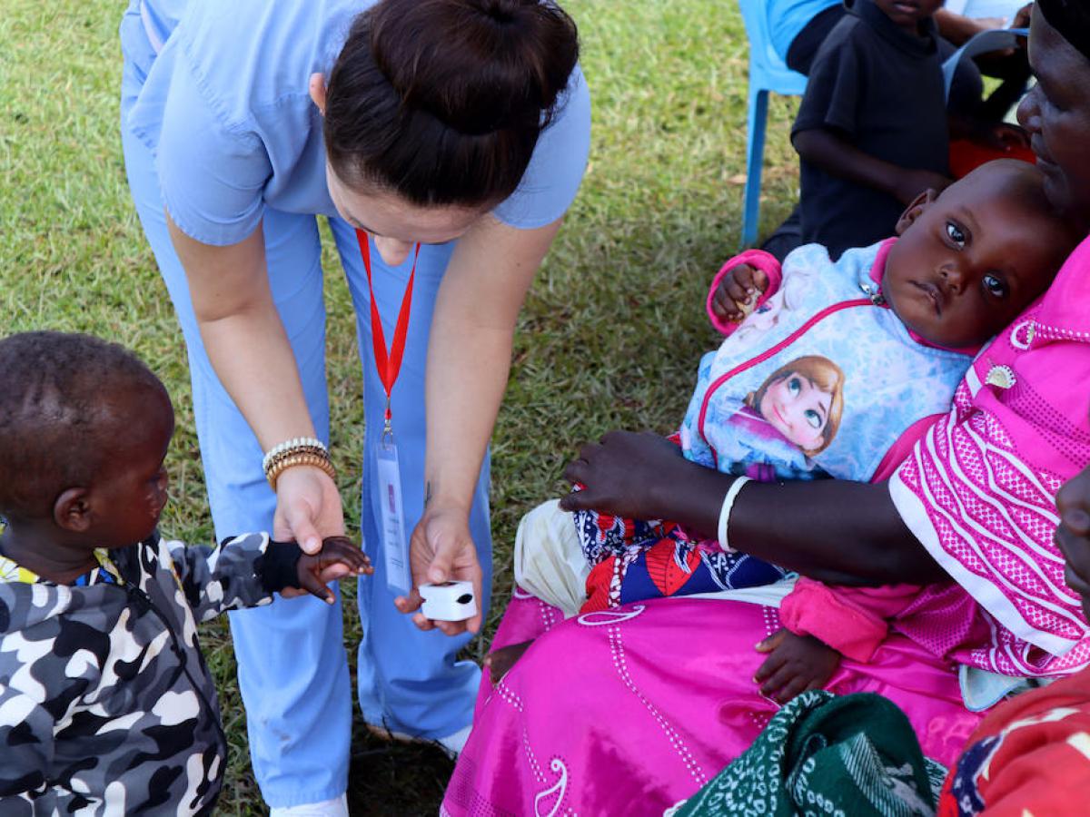 Medical volunteer examining child