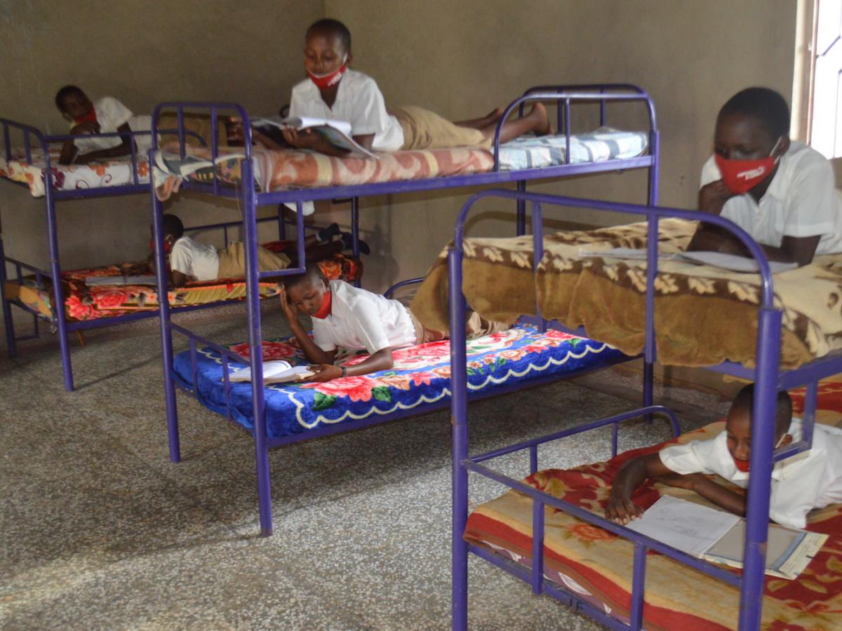 Children reading in school dormitory