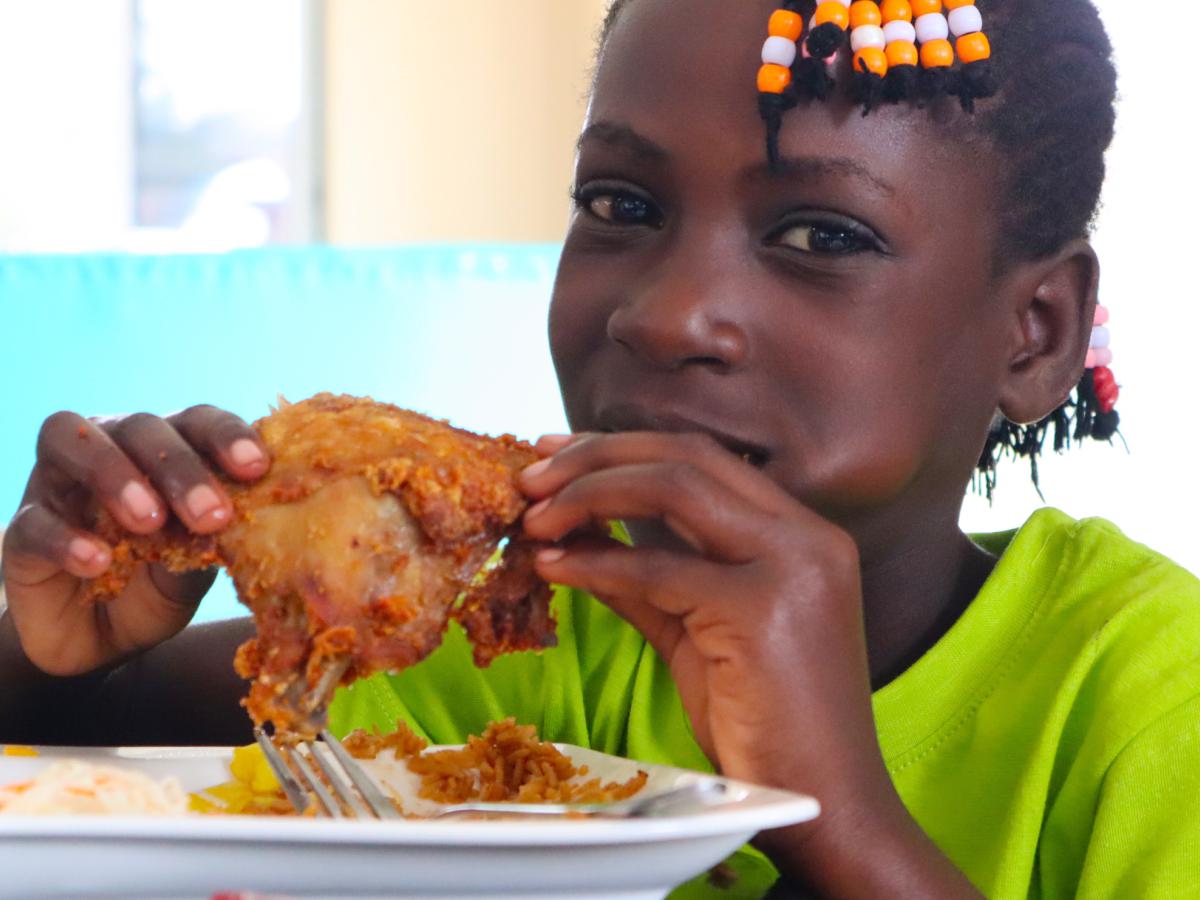 Young person eating fried chicken